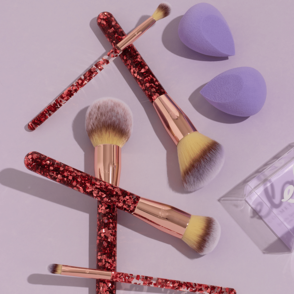 sparkling makeup brush set and purple beauty sponge